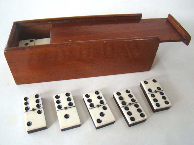 A wonderful boxed set of 19th century bone and ebony dominoes